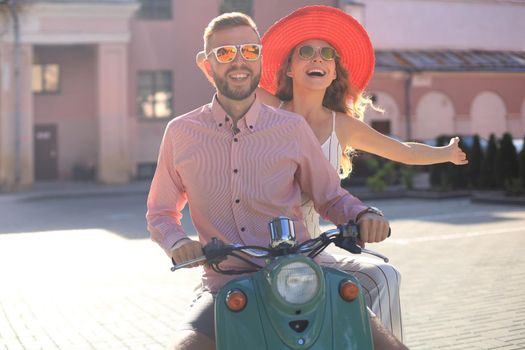 Young beautiful couple riding on motorbike. Adventure and vacations concept