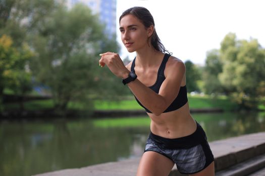 Young woman in sports clothing running while exercising outdoors