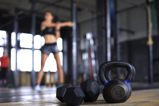 Young sporty woman stretching at the gym