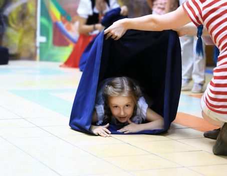 closeup. a little girl on holiday in the children's entertainment center.