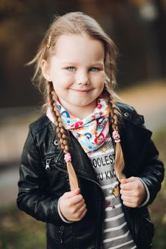 Cheerful happy girl in warm clothes smiles and enjoys of her life