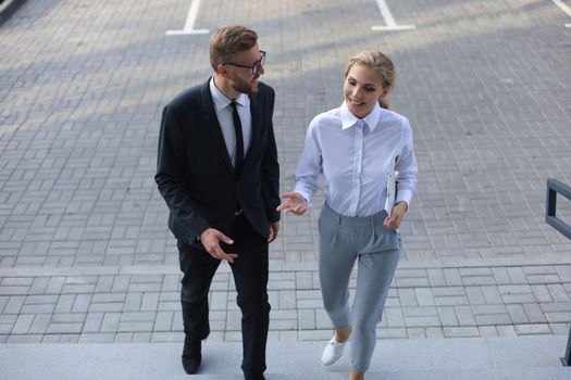 Business man and woman walking in the office center