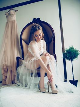 bride's morning. beautiful girl trying on elegant wedding shoes. photo with copy space