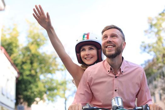 Young beautiful couple riding on motorbike. Adventure and vacations concept