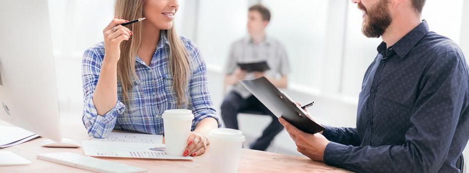 employees discussing business documents in the office. office weekdays