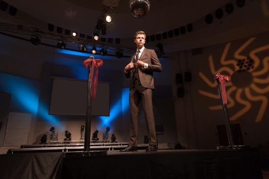 confident male model showing off business suit during fashion show