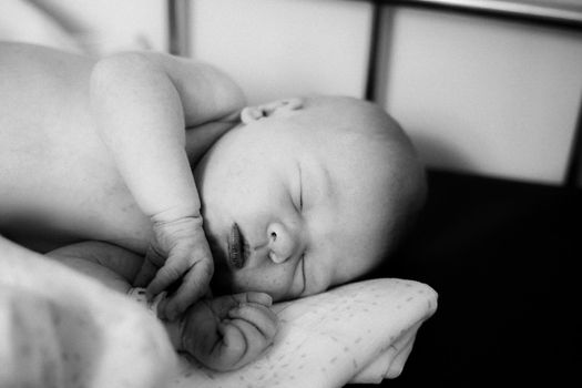 photo in retro style.Sleeping newborn resting in bed. close up