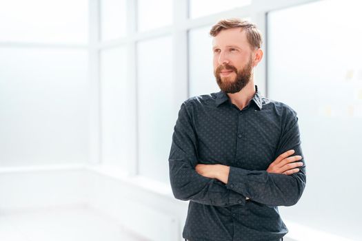 successful businessman standing near the office window. photo with copy space