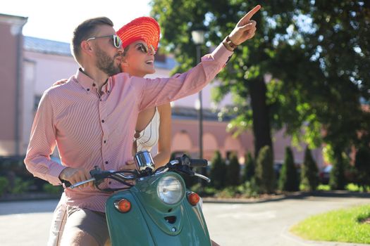 Young beautiful couple riding on motorbike. Adventure and vacations concept