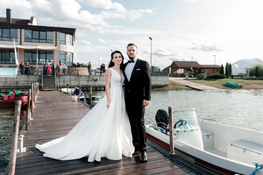 happy bride and groom standing on the pier. holidays and events