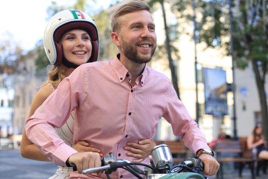 Young couple in love riding a motorbike. Riders enjoying themselves on trip. Adventure and vacations concept