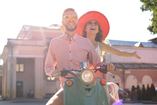 Young beautiful couple riding on motorbike. Adventure and vacations concept