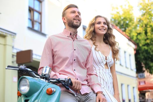 Young beautiful couple riding on motorbike. Adventure and vacations concept