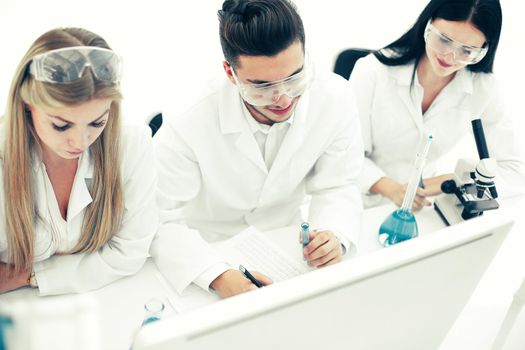 top view.a group of scientists working on a computer in the laboratory . science and health
