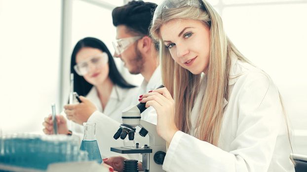 close up. a group of scientists conduct research in a modern laboratory. science and health