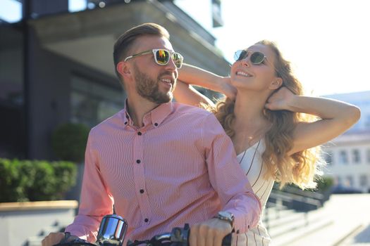 Young beautiful couple riding on motorbike. Adventure and vacations concept