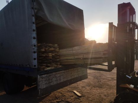 close up. loading wooden boards in a truck. photo with copy space