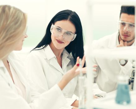 close up.a team of scientists discuss the results of the experiments . science and health