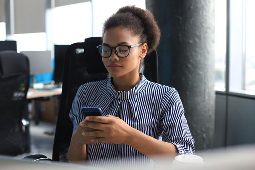 Beautiful afro american woman using mobile phone. Communication concept