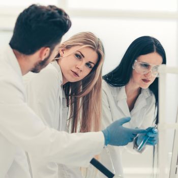 group of young scientist discussing research results . photo with copy space