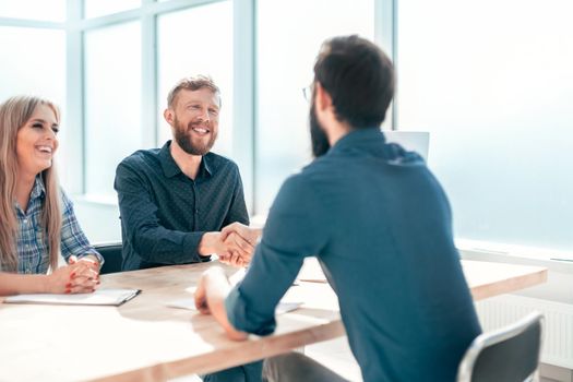 Manager shaking hands with the applicant during the interview. the concept of employment
