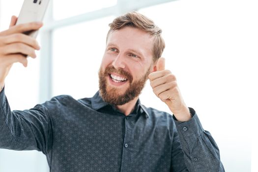 happy businessman talking on video link on his smartphone. photo with copy space