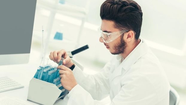 modern scientist examines test tube with liquid. science and health
