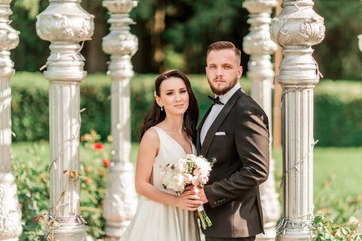 close up. bride and groom standing in an arched gazebo .holidays and events