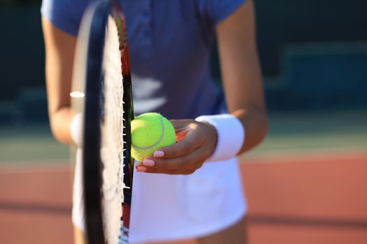 Close up of a tennis player hitting the ball with racket