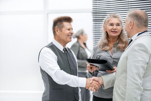 close up. friendly business people shaking hands with each other. the concept of cooperation