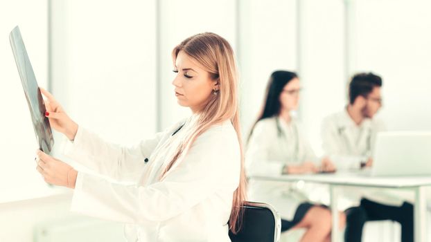 young physician therapist looks at the x-ray of the patient .photo with copy space