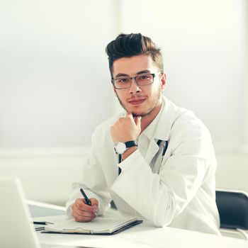 doctor therapist sitting at a table in his office.photo with copy space