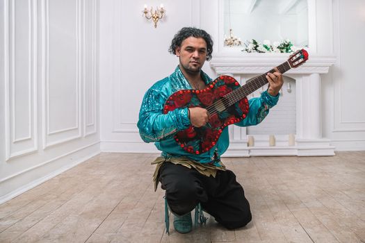 brutal man Gypsy with a guitar singing a song. photo with copy space