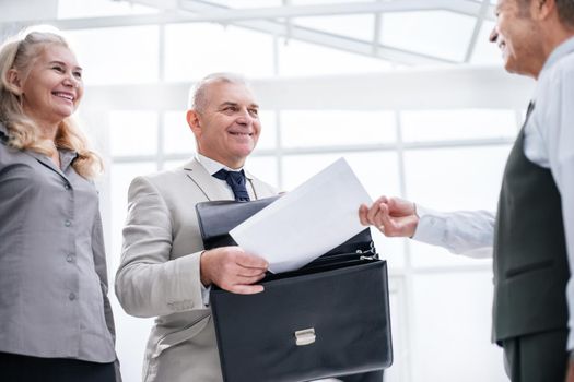 close up. businessman receiving document from Bank employee. business concept