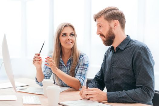 employees discussing online data in the office. office weekdays