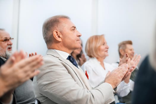 close up. a group of business people applaud during a business seminar. business and education
