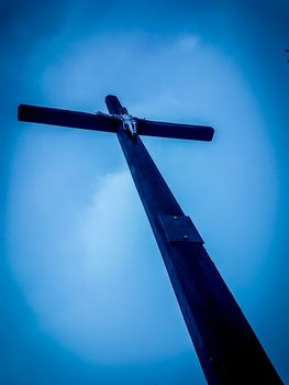 close up.spire with a crucifix on the dome of the Catholic Church.