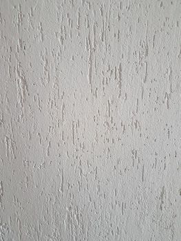 close up. fragment of white non-woven Wallpaper. background and texture