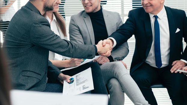 business partners shaking hands at a work meeting. business concept