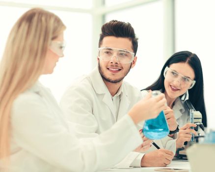 close up.a team of scientists sitting at the laboratory table . science and health