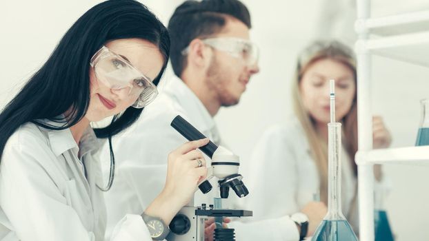 female scientist uses a microscope in the laboratory. science and health