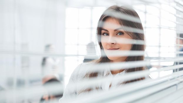 young business woman standing near office window. photo with copy-space