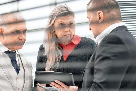 close up. a group of business people standing in the lobby of a modern office. business concept