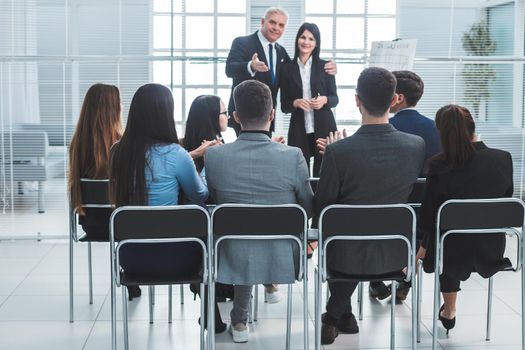 boss representing a young specialist during a work meeting. success concept