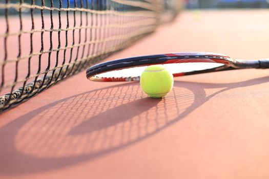 Tennis racket and the ball on tennis court