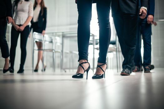 close up. image of a group of corporate employees walking in the office
