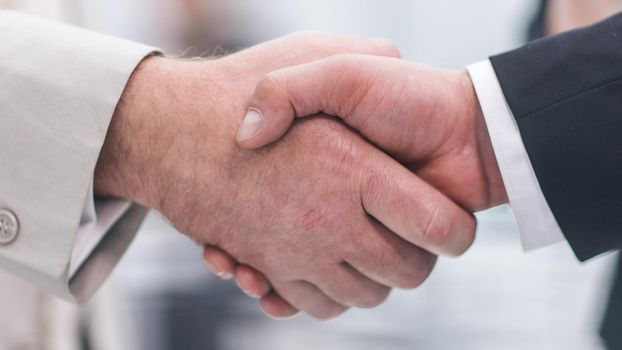 close up. business handshake on the background of the office. business concept
