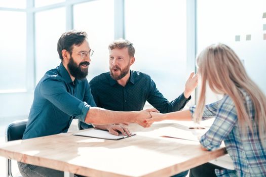 employer shaking hands with a young woman during the interview. concept of cooperation