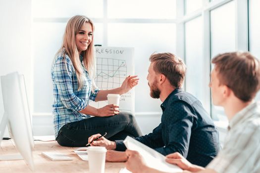 young woman discussing with colleagues new strategy. the concept of teamwork