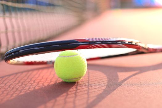 Tennis racket and the ball on tennis court